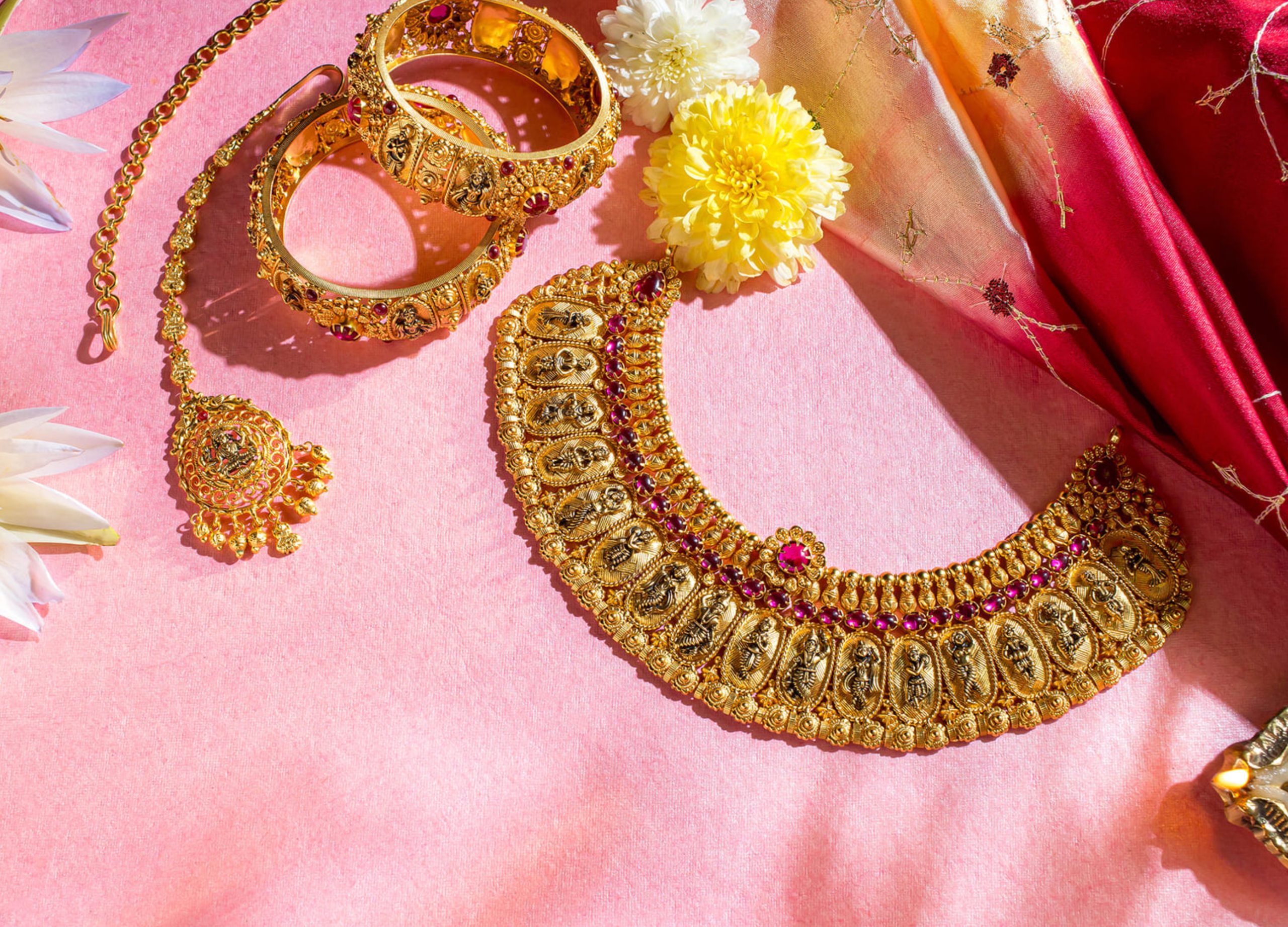 exquisite-gold-jewelry-set-pink-surface