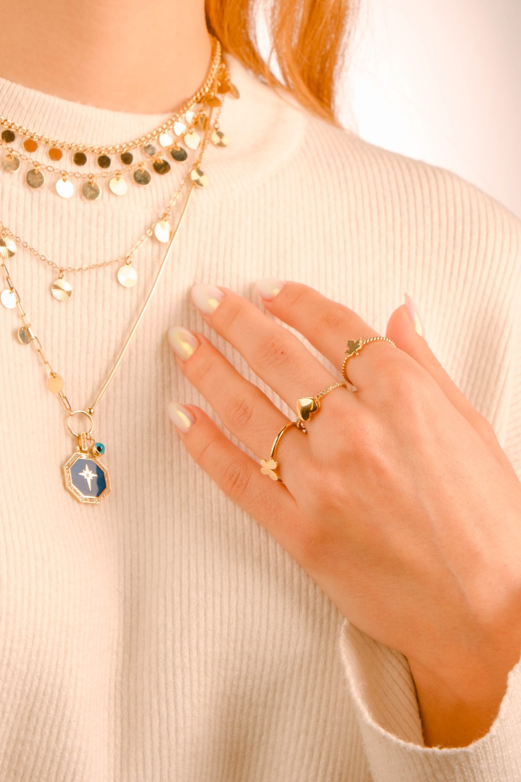 womans-hand-neck-adorned-with-gold-jewelry